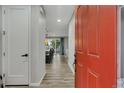 Bright entryway with plank floors, red front door, and an open view of the dining area at 25062 E Cedar Pl, Aurora, CO 80018