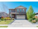 Charming two-story home with stone accents, front lawn, and a two-car attached garage at 25062 E Cedar Pl, Aurora, CO 80018