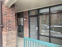 Close-up of the building entrance with glass doors and windows, providing natural light at 3872 S Dallas St # 7-107, Aurora, CO 80014