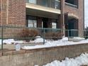 Exterior view of the entrance, featuring brickwork, landscaping, and accessibility features at 3872 S Dallas St # 7-107, Aurora, CO 80014