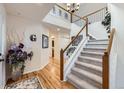 Bright foyer with staircase, chandelier, and hardwood floors, creating an elegant entrance at 1525 E 133Rd Ave, Thornton, CO 80241