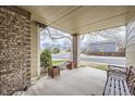Spacious front porch with brick columns, creating a comfortable outdoor space at 1525 E 133Rd Ave, Thornton, CO 80241