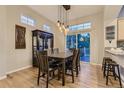 Dining area featuring modern lighting, a table with chairs, and sliding glass doors to the outside at 3120 Redhaven Way, Highlands Ranch, CO 80126