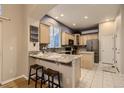 Well-appointed kitchen with granite countertops, stainless steel appliances, and breakfast bar at 3120 Redhaven Way, Highlands Ranch, CO 80126