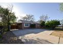 Charming brick home features a carport, well-maintained landscaping, and a spacious driveway at 2211 Quebec St, Denver, CO 80207