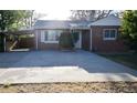 Charming brick home features a carport and a spacious driveway at 2211 Quebec St, Denver, CO 80207