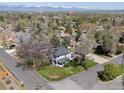 Aerial view of a home in a leafy neighborhood with mountain views at 5801 W 33Rd Ave, Wheat Ridge, CO 80212