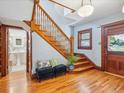 Elegant foyer with wood staircase, hardwood floors, and stylish decor at 5801 W 33Rd Ave, Wheat Ridge, CO 80212