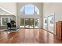 Bright living room featuring hardwood floors, large windows and doors leading to the outdoor view at 27987 Pine Grove Trl, Conifer, CO 80433