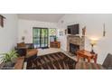 Living room with stone fireplace and sliding door to a balcony at 8654 Decatur St # 251, Westminster, CO 80031