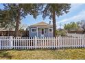 Charming home with a white picket fence and mature trees in a serene setting at 4290 S Cherokee St, Englewood, CO 80110