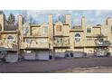 Exterior of townhomes with garages and balconies in a well maintained community at 1818 S Quebec Way # 11-3, Denver, CO 80231