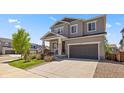 Attractive two-story house with a well-kept lawn and an attached two-car garage on a sunny day at 1114 Basalt Ridge Loop, Castle Rock, CO 80108