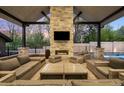 Inviting outdoor living area featuring a stone fireplace, comfortable seating, and elegant design details at 2821 E Cedar Ave # 2, Denver, CO 80209