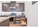 Kitchen features stainless steel appliances, granite countertops, and ample storage with pull-out drawers at 16841 Askins Loop # 101, Parker, CO 80134
