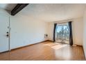A bright living room features a slider to the balcony, and wood flooring, creating a cozy and inviting space at 16259 W 10Th Ave # J5, Golden, CO 80401