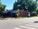 Brick duplex featuring street view and mature landscaping at 292 S Lafayette St, Denver, CO 80209