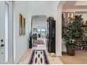 Inviting foyer with tile flooring, arched doorways, and decorative furnishings and artwork at 9483 Sori Ln, Highlands Ranch, CO 80126