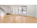 Light-filled living room with hardwood floors and large windows at 10330 E Jewell Ave # 67, Aurora, CO 80247