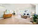 Bright living room featuring hardwood floors, neutral decor, and large windows providing plenty of natural light at 16438 E Prentice Cir, Centennial, CO 80015