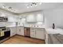 Modern kitchen features stainless steel appliances, white cabinetry, and quartz countertops at 745 S Alton Way # 11A, Denver, CO 80247