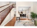 Open concept foyer leading to the dining room, showcasing hardwood floors and natural light at 3761 S Orleans St, Aurora, CO 80013
