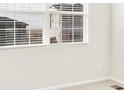 Bright bedroom with neutral carpet, a window with blinds, and clean, neutral walls at 17417 E 89Th Way, Commerce City, CO 80022