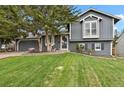 Beautiful home with a well-manicured lawn, mature trees, and an inviting exterior at 5870 S Perth Pl, Centennial, CO 80015