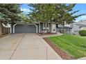Lovely home featuring a two-car garage, mature trees, and a well-maintained lawn at 5870 S Perth Pl, Centennial, CO 80015