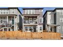 Charming two-story townhome with a fenced front yard and inviting front porch at 14998 Cast Pebble Cir, Parker, CO 80134