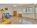 Cozy bedroom with a large window, ceiling fan, and light parquet flooring at 13901 E Marina Dr # 113, Aurora, CO 80014