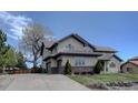 Exterior showcasing a spacious driveway, garage, and stone detailing at 14993 W 55Th Dr, Golden, CO 80403