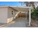 Attached carport featuring a concrete floor and support beams offering sheltered parking at 1050 Uvalda St, Aurora, CO 80011