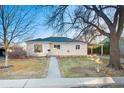 Charming single-story home with a welcoming walkway and a convenient carport at 1050 Uvalda St, Aurora, CO 80011