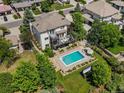 A backyard oasis with a beautiful swimming pool, outdoor seating, fire pit, and lush green lawn at 10057 S Shadow Hill Dr, Lone Tree, CO 80124
