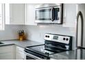 Updated range with a stainless steel Frigidaire microwave in the kitchen at 2714 N Federal Blvd, Denver, CO 80211