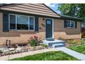 Close up of single-story home showing landscaped front yard and brick facade at 2069 E 116Th Ave, Northglenn, CO 80233
