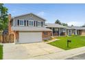 Charming two-story home with a well-manicured front yard and a two-car garage in a suburban setting at 11021 Otis St, Westminster, CO 80020