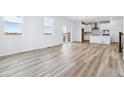 Open concept kitchen and dining area with white cabinets and an island at 2060 Chambers Rd, Brighton, CO 80601