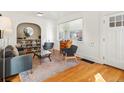 Inviting living room with hardwood floors, a cozy seating area, and a large window providing ample natural light at 2635 N Clayton St, Denver, CO 80205