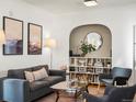 Stylish living room showcasing a comfortable sofa, armchairs, and a built-in bookshelf with archway detail at 2635 N Clayton St, Denver, CO 80205