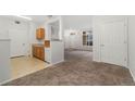 Open floorplan view of living area and kitchen with neutral color scheme at 1535 S Florence Way # 407, Aurora, CO 80247