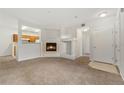 Bright living room featuring a modern fireplace and neutral carpeting at 1535 S Florence Way # 407, Aurora, CO 80247