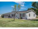 Charming single-story home featuring a well-maintained lawn and classic vinyl siding at 8260 County Road 39, Fort Lupton, CO 80621