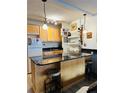 Charming kitchen featuring updated cabinets, granite countertop bar, and attractive lighting at 909 N Logan St # 6D, Denver, CO 80203