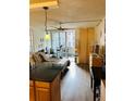 Comfortable living area featuring hardwood floors, sliding glass doors, and modern ceiling fan at 909 N Logan St # 6D, Denver, CO 80203
