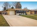 Exterior view showcasing the attached garage and well-kept front yard at 169 Emerald St, Broomfield, CO 80020