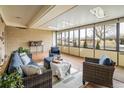 Bright sunroom featuring walls of windows, seating and tile flooring at 169 Emerald St, Broomfield, CO 80020