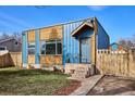 Unique home with blue siding, wood accents, and a well-manicured front lawn at 1937 Jay St, Lakewood, CO 80214