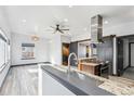Open-concept kitchen featuring modern appliances, granite counters, and easy access to living area at 1937 Jay St, Lakewood, CO 80214